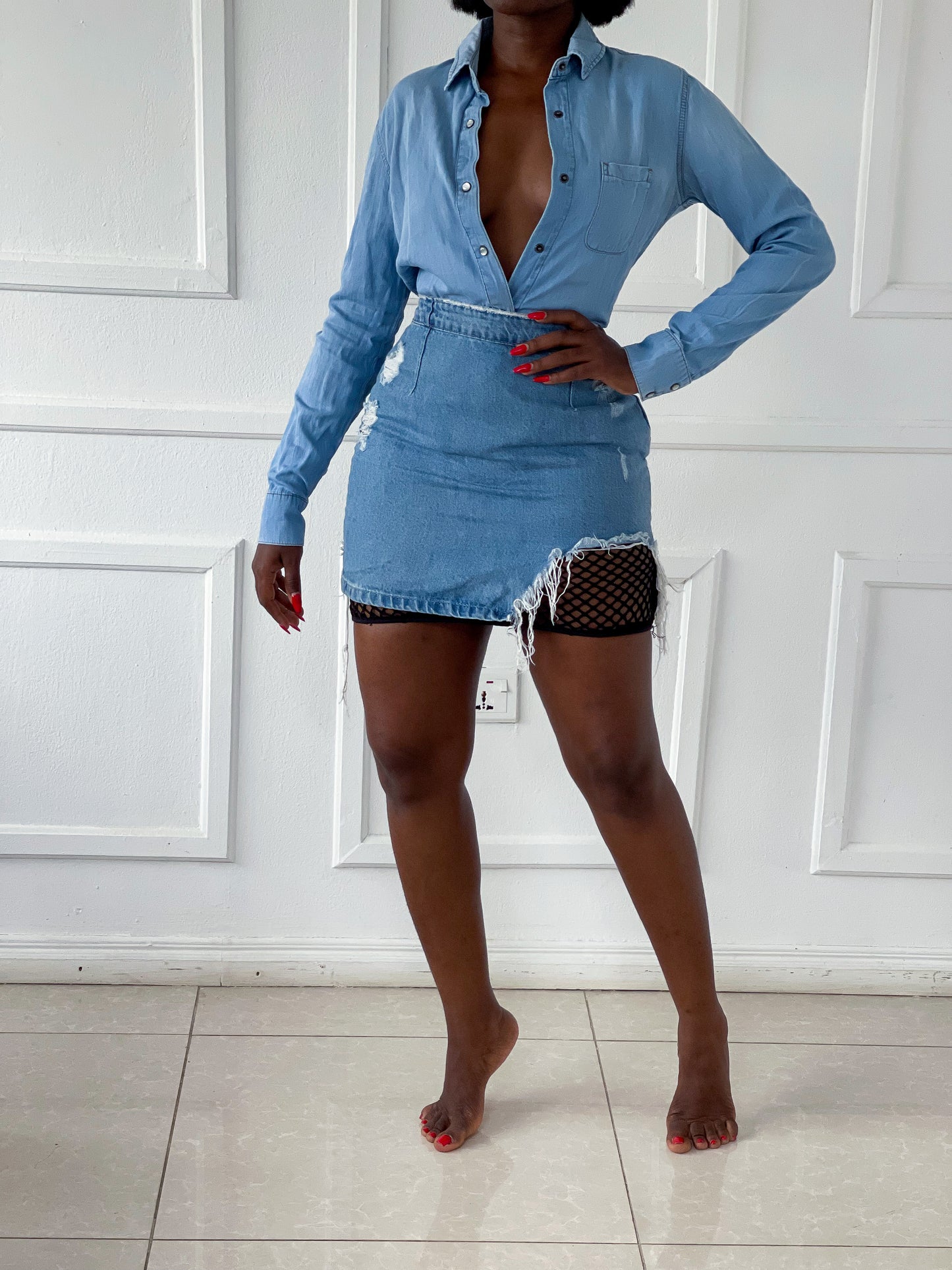 Light wash denim skirt with fishnet hem